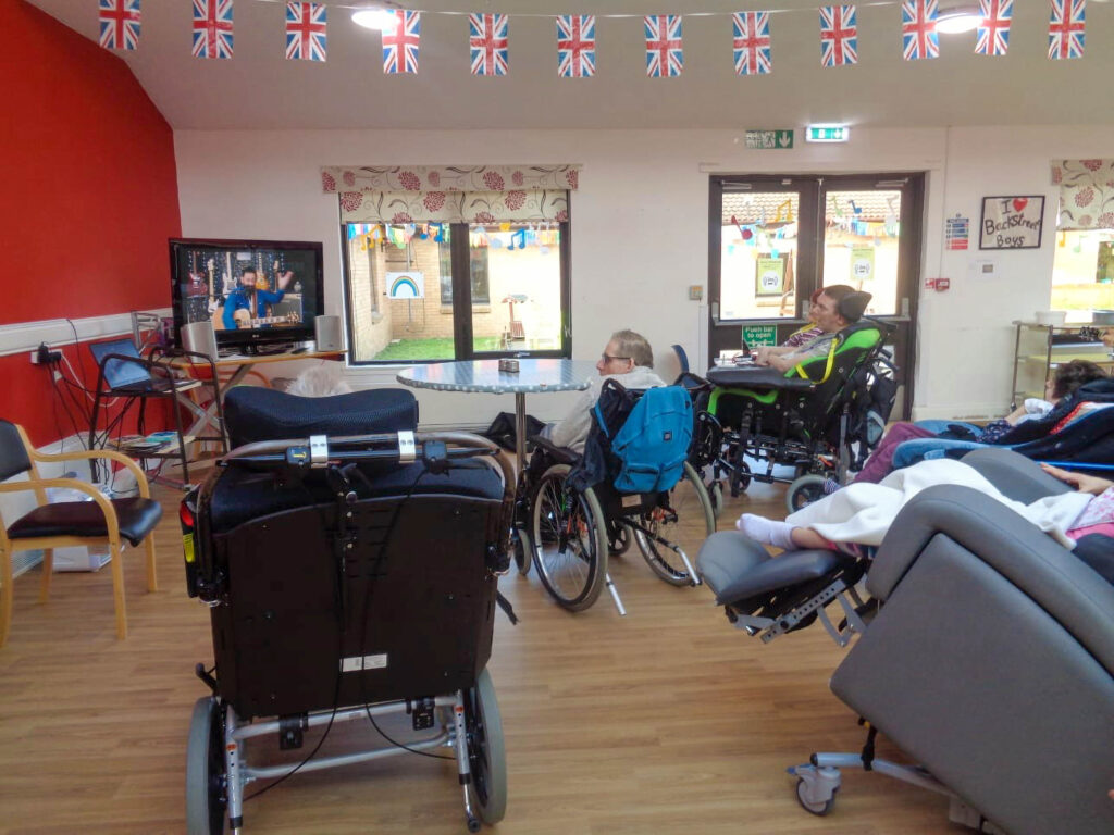 Residents viewing live music on a TV