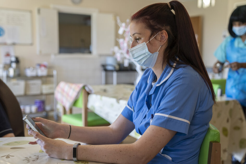 care worker using mobile device